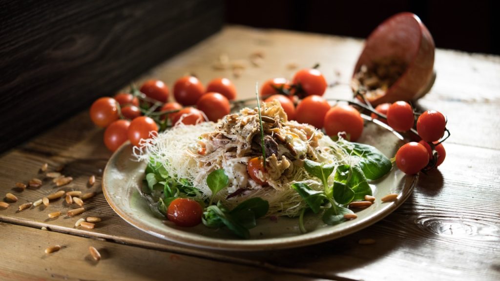 Gallina padovana nel suo "nido" croccante di pasta filo, valeriana, spuma di caprino, pomata al pomodoro, pinoli e uvetta